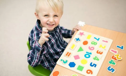 Young child exploring learning toys